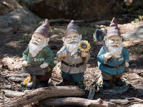 Three welcoming garden gnomes ready to work.