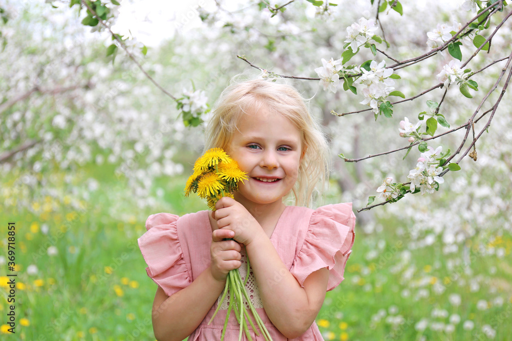 Cute LIttle Girl Child Picking Flowers Under APple Trees in Orchard Cute LIttle Girl Child Picking Flowers Under APple Trees in Orchard