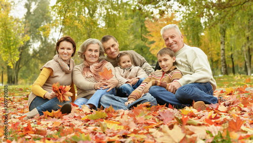 Portrait of family relaxing in autumn park