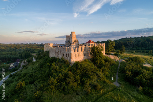 Rabsztyn, Poland. Ruins of medieval royal castle on the rock in Polish Jurassic Highland. Aerial view in sunrise light in summer