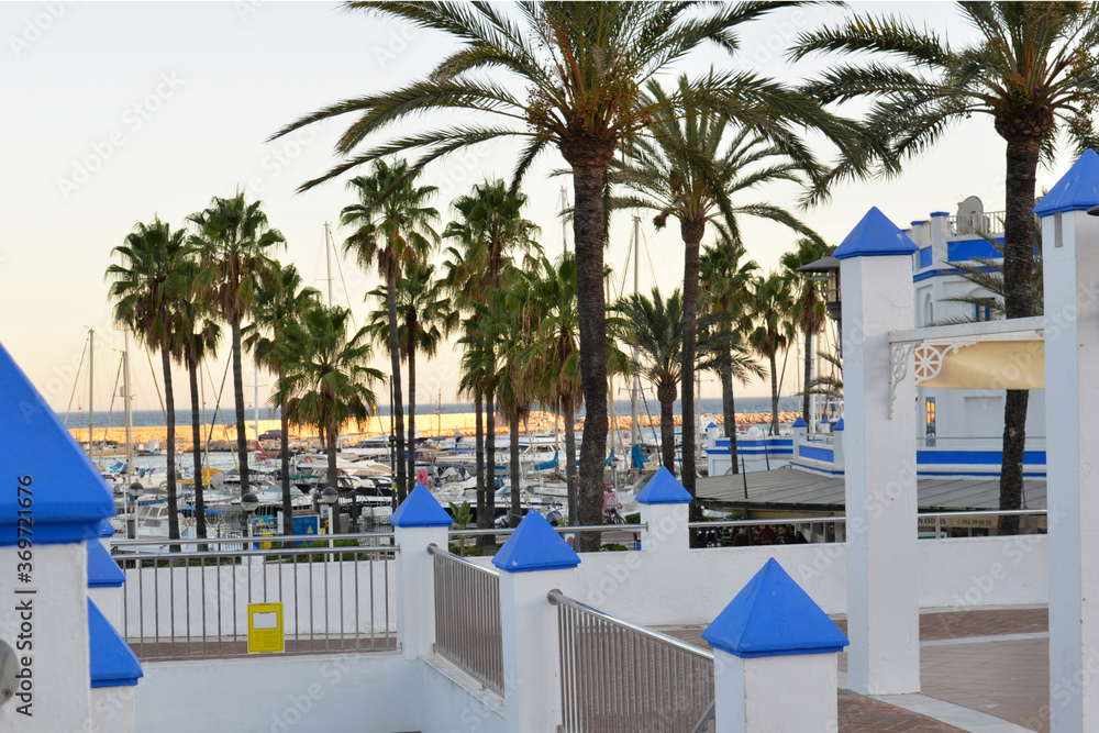 View of the yacht parking from the terrace with white and blue pillars.