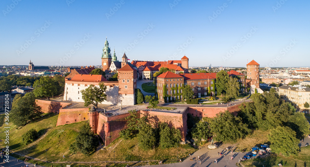 Royal Wawel Cathedral and castle in Krakow, Poland. Aerial view in sunset light in summer with a park,  promenade and  walking people