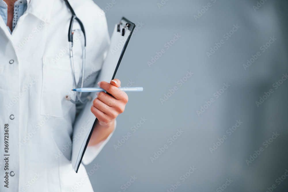 Close up view of young nurse that indoors in modern clinic. Conception of healthcare Close up view of young nurse that indoors in modern clinic. Conception of healthcare