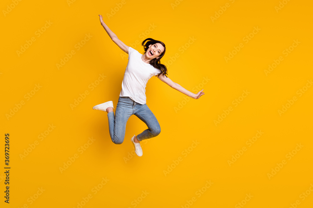 Full length body size view of her she pretty cheerful cheery careless thin girl jumping flying like plane wings having fun active life isolated bright vivid shine vibrant yellow color background