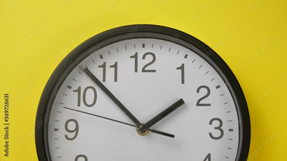Office Clock Hanging on a Yellow Color Wall Office Clock Hanging on a Yellow Color Wall