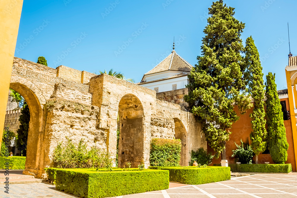 A view across the entrance courtyard of the Alcazar Palace in Seville, Spain in the summertime