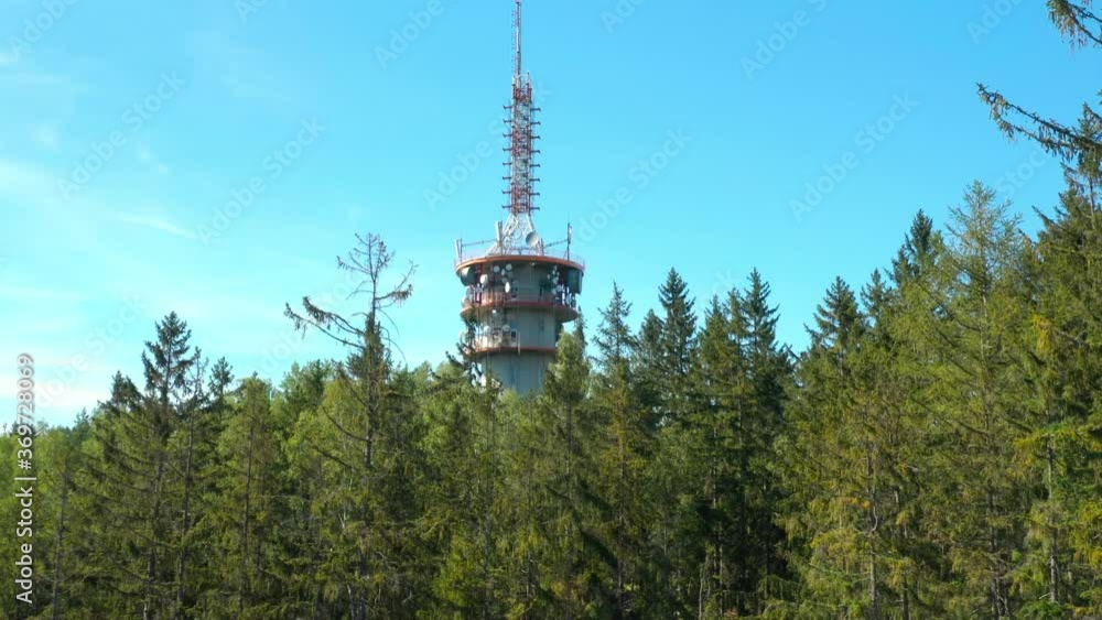 Television and telecomunication transmitter tower on peak in natural reserve. Modern technologies in Bohemian landscape. Czech Republic. Television and telecomunication transmitter tower on peak in natural reserve. Modern technologies in Bohemian landscape. Czech Republic.