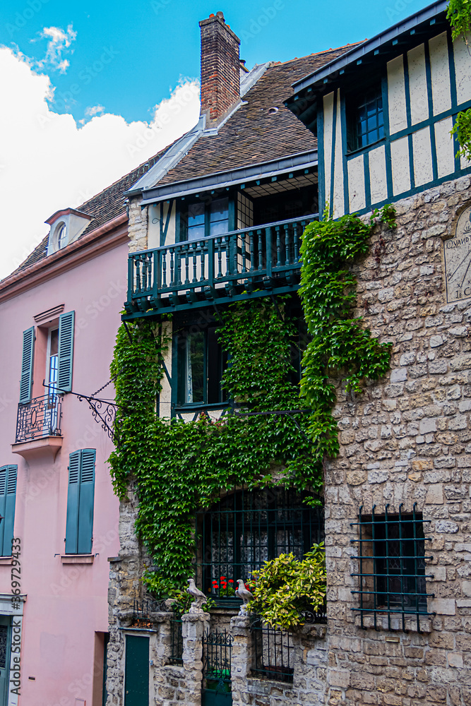 Old French house in Paris Montmartre District. Montmartre is one of most colorful neighborhoods in Paris. France.