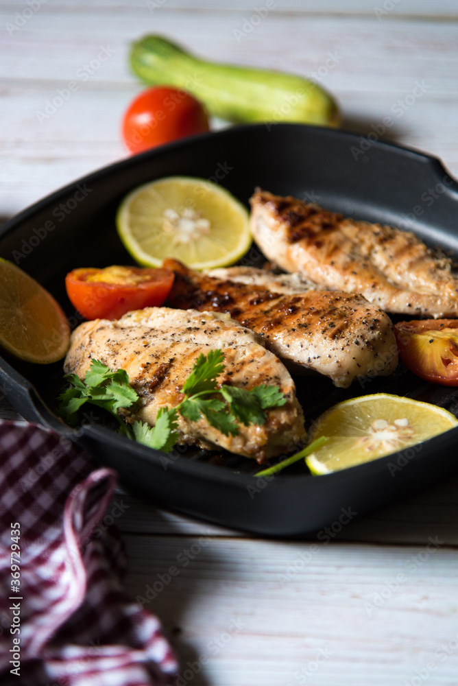 Pan fried meat with vegetables and ingredients and condiments in a pan with use of selective focus Pan fried meat with vegetables and ingredients and condiments in a pan with use of selective focus