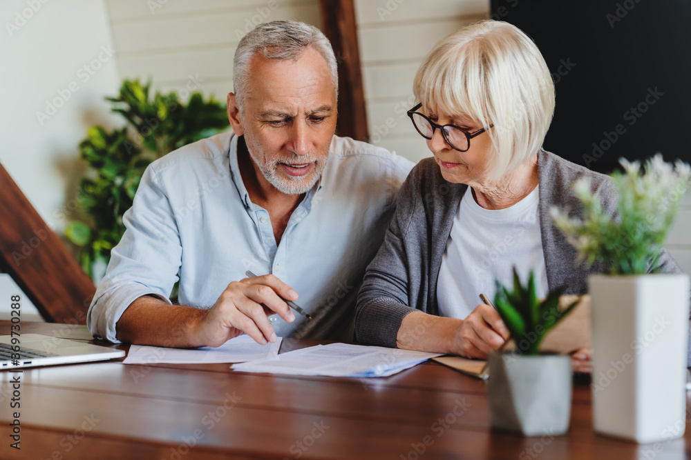 © InsideCreativeHouse - Mature couple with financial documents in home interior © InsideCreativeHouse - Mature couple with financial documents in home interior