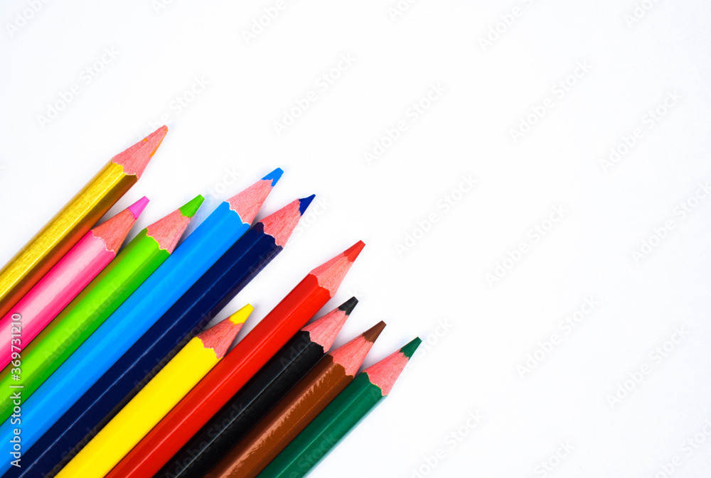 Some different colored wood pencil crayons scattered on a white background Some different colored wood pencil crayons scattered on a white background