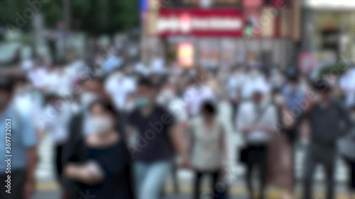Wallpaper Mural TOKYO, JAPAN - JUL 2020 : Crowd of people at the street near Shinjuku station in rush hour. Commuters wearing surgical mask to protect from Coronavirus (COVID-19) in hot summer season. Blurred shot. Torontodigital.ca