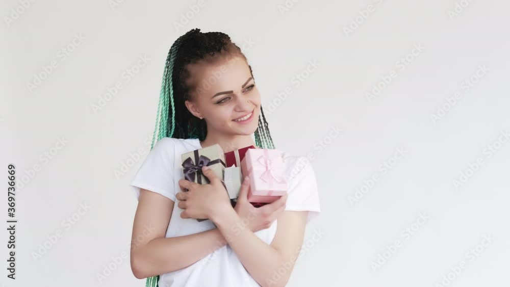 Birthday surprise. Special day. Happy woman with blue colored hair braids enjoying greeting with gift boxes isolated on white copy space. Creative ethnic hairstyle. Bright dreads. Birthday surprise. Special day. Happy woman with blue colored hair braids enjoying greeting with gift boxes isolated on white copy space. Creative ethnic hairstyle. Bright dreads.