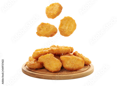 Wooden board with chicken nuggets isolated on white background photo