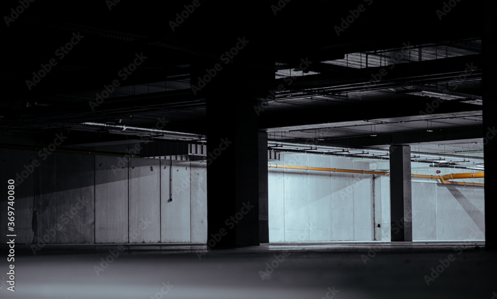 Obraz premium Entrance to underground car park during the day. Outdoor area is bright ,indoor area is dark.