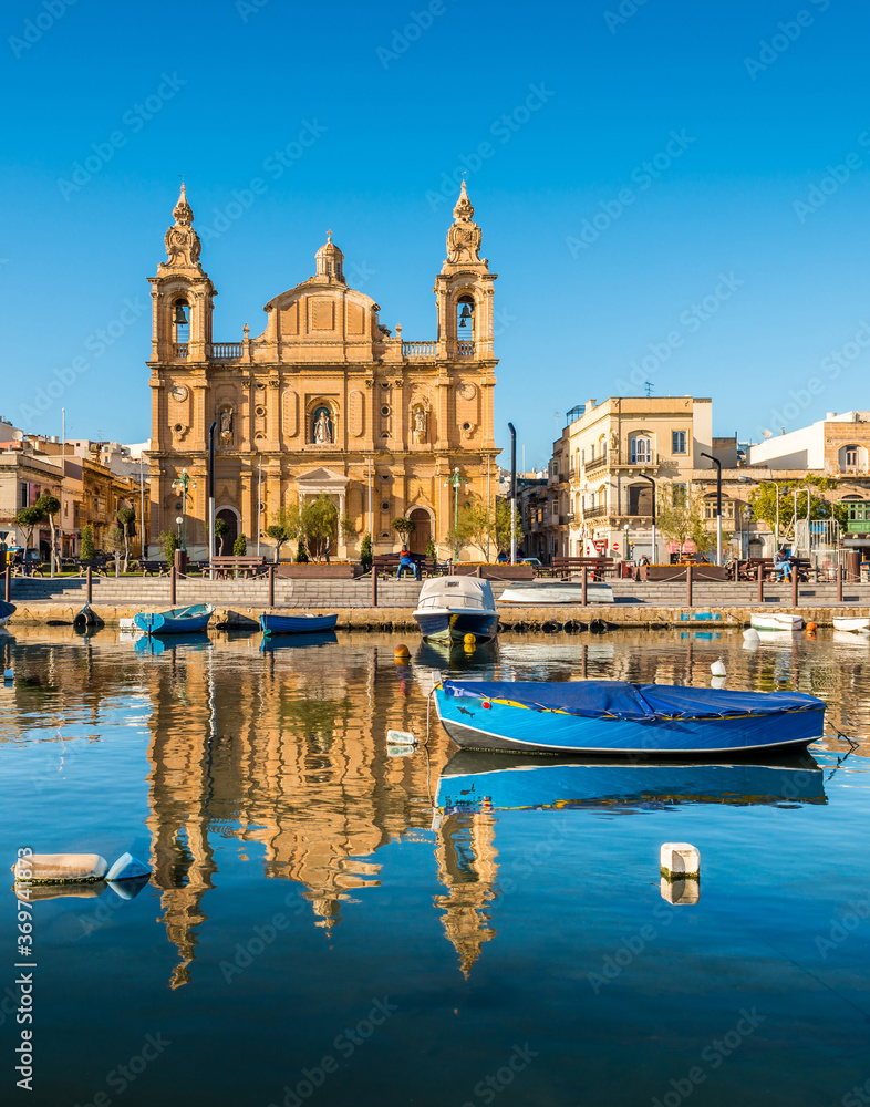 Church and fishing boats in Sliema, Malta