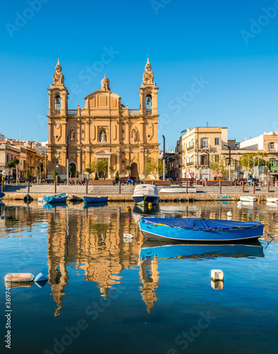 Church and fishing boats in Sliema, Malta