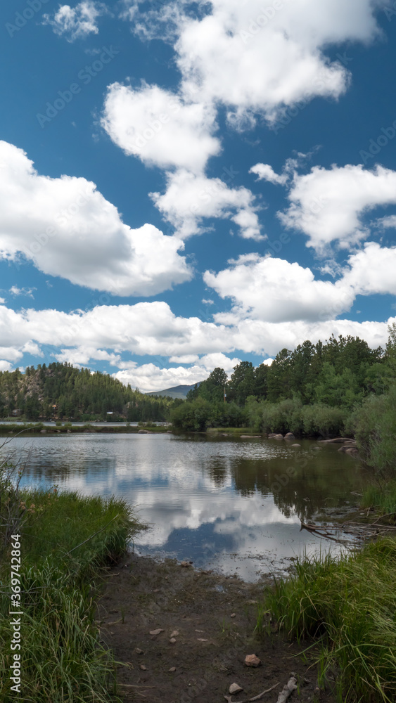 Clouds reflecting of the water of the beautiful private Lake Hiawatha in Red Feather Lakes, Colorado. Clouds reflecting of the water of the beautiful private Lake Hiawatha in Red Feather Lakes, Colorado.