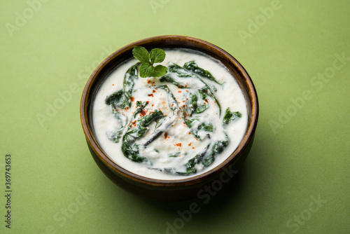 Spinach Yogurt Salad or Palak Raita served in a bowl photo