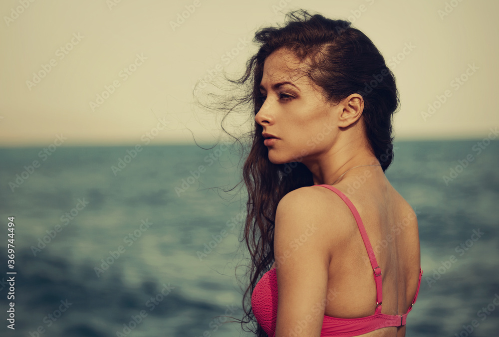 Beautiful serious thinking woman looking on the blue sea on summer holadays with empty copy space. Healthy face skin and long windy hair of female model. Closeup fashion profile portrait. Vintage Beautiful serious thinking woman looking on the blue sea on summer holadays with empty copy space. Healthy face skin and long windy hair of female model. Closeup fashion profile portrait. Vintage