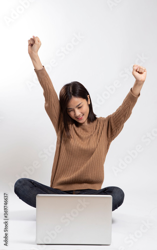 The Asian woman sitting on the white background.