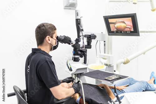 The dentist examines the patient's teeth with a dental microscope. Modern medical equipment © F8 \ Suport Ukraine