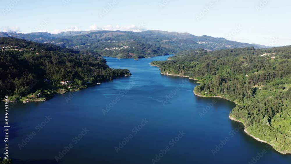 Flying Over The Calm Blue Waters Surrounded By Lush Trees In Rio Vouga, Portugal - aerial drone Flying Over The Calm Blue Waters Surrounded By Lush Trees In Rio Vouga, Portugal - aerial drone