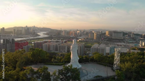 Aerial shot approaching Goddess A-Ma statue from behind with Macau skyline photo