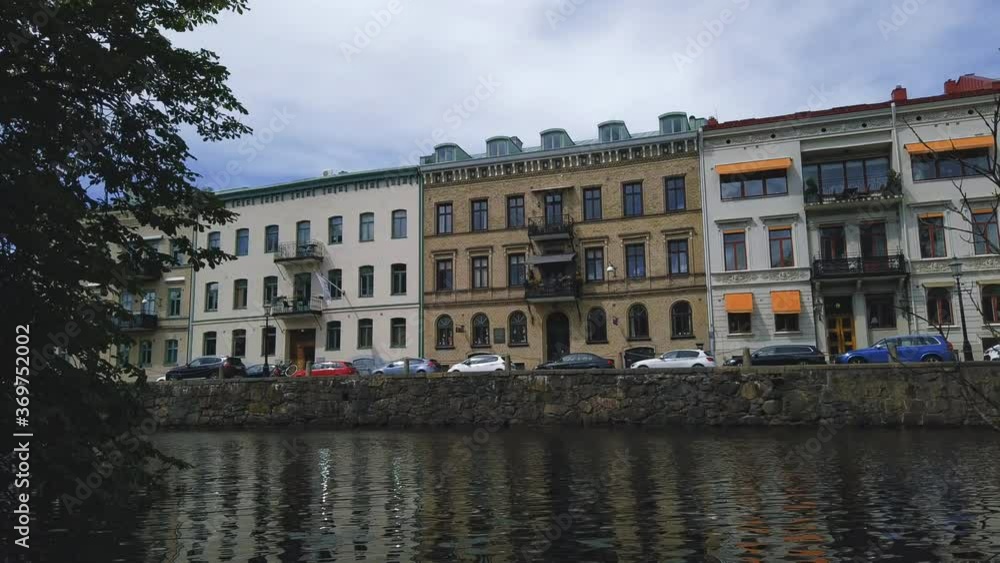 Buildings along Gothenburg canal in sunny day. Time lapse, pan right Buildings along Gothenburg canal in sunny day. Time lapse, pan right