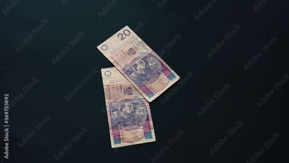 The Ukrainian hryvnia in the amount of a thousand hryvnias falls, flies on a black background, the Ukrainian state currency, a lot of bills.2021 The Ukrainian hryvnia in the amount of a thousand hryvnias falls, flies on a black background, the Ukrainian state currency, a lot of bills.2021