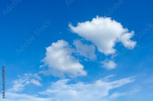 Cirrus and cumulus clouds on blue sky background.