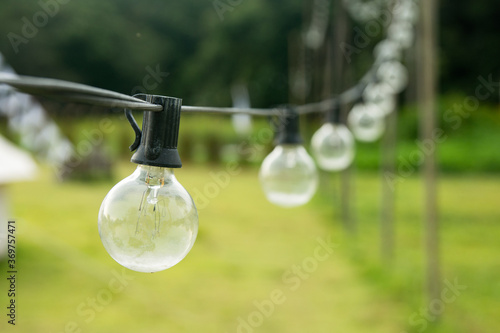 Outdoor string Light bulbs hanging on a line.