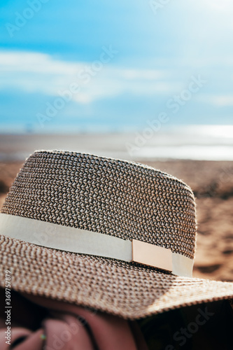 Womans Straw hat on the beach, summer staycation photo