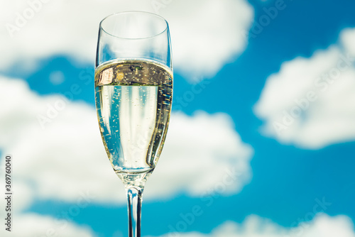 Glass of Prosecco from low angle view with beautiful sky as background