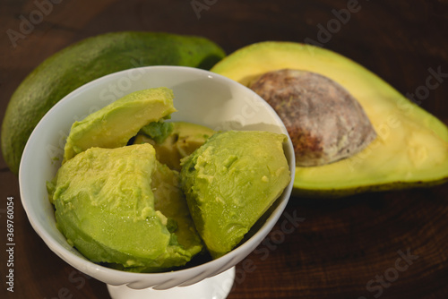 avocado butter, sliced on dark wooden background, copy space