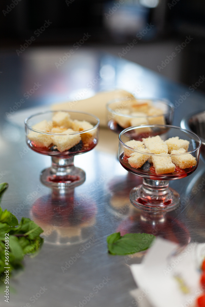 The pastry chef prepares a trifle in the kitchen The pastry chef prepares a trifle in the kitchen