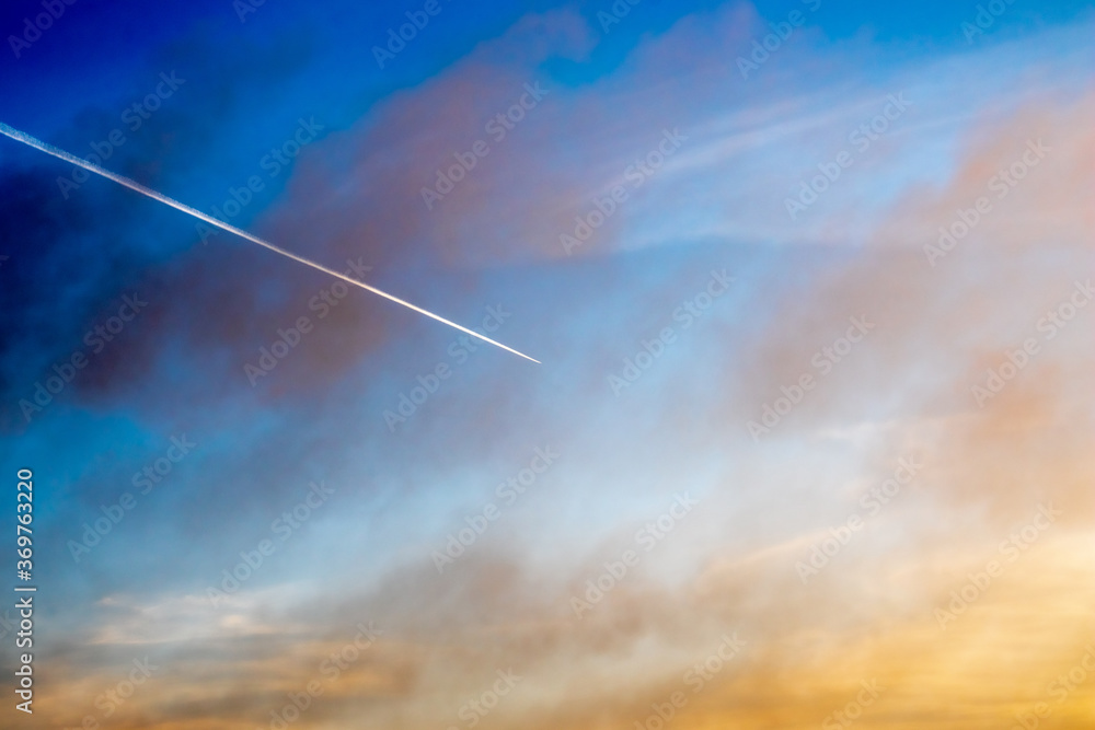 Diagonal airplane trace in a high contrast sky Diagonal airplane trace in a high contrast sky