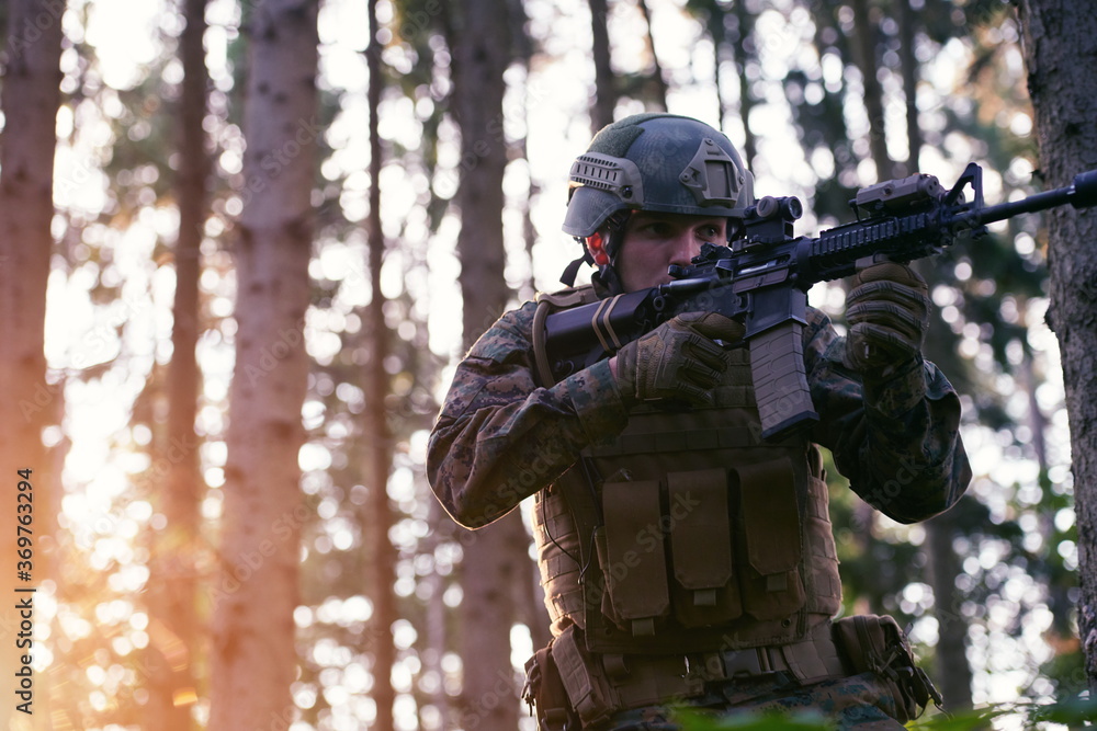Fototapeta premium soldier in action aiming on weapon laser sight optics