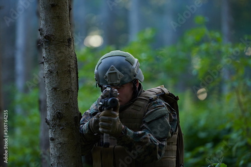 soldier in action aiming on weapon laser sight optics