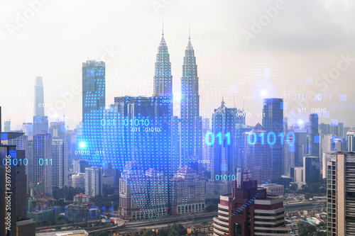 World planet Earth map hologram over panorama city view of Kuala Lumpur  Malaysia  Asia. The concept of international connections and business. Multi Exposure.