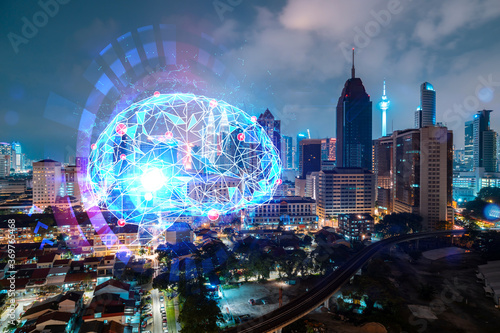 Human brain hologram, aerial panoramic city view of Kuala Lumpur at night. KL is the educational cluster in Malaysia, Asia. The concept of artificial intelligence. Double exposure.