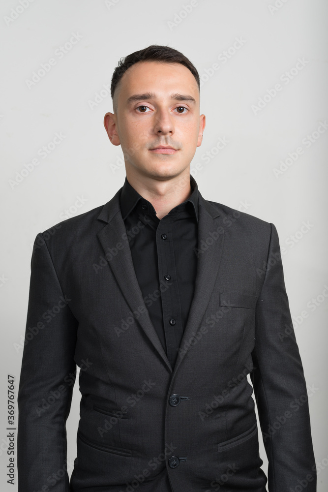 Portrait of handsome businessman in suit against white background Portrait of handsome businessman in suit against white background