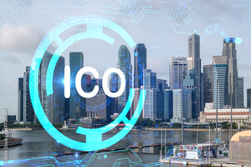 ICO icon hologram over panorama city view of Singapore, the hub of blockchain projects in Asia. The concept of initial coin offering. Double exposure.