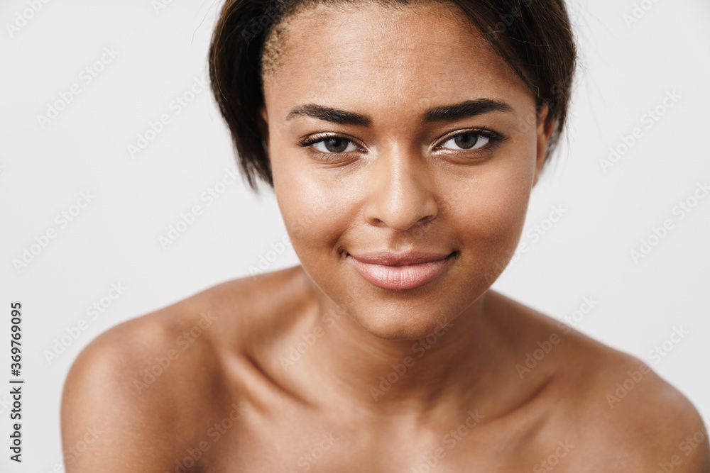 Image of half-naked african american woman smiling and looking at camera Image of half-naked african american woman smiling and looking at camera
