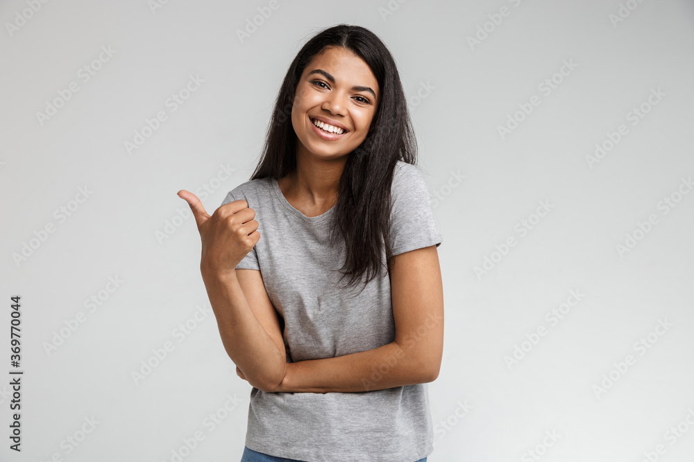 Smiling young african woman pointing at copy space Smiling young african woman pointing at copy space