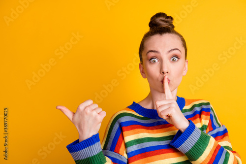 Photo of shocked girl point index finger copyspace indicate voiceless speechless ads promo ask dont share private news put hand mouth wear jumper isolated over shine color background photo