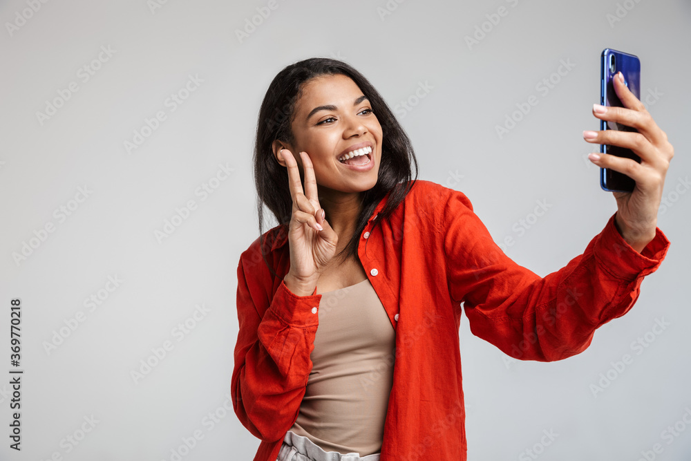 Naklejka premium Young funny african casual lady grimacing