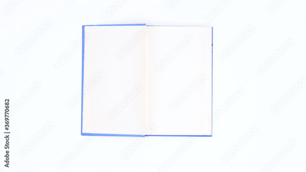 Light blue covered book appear and open. Stop motion Light blue covered book appear and open. Stop motion