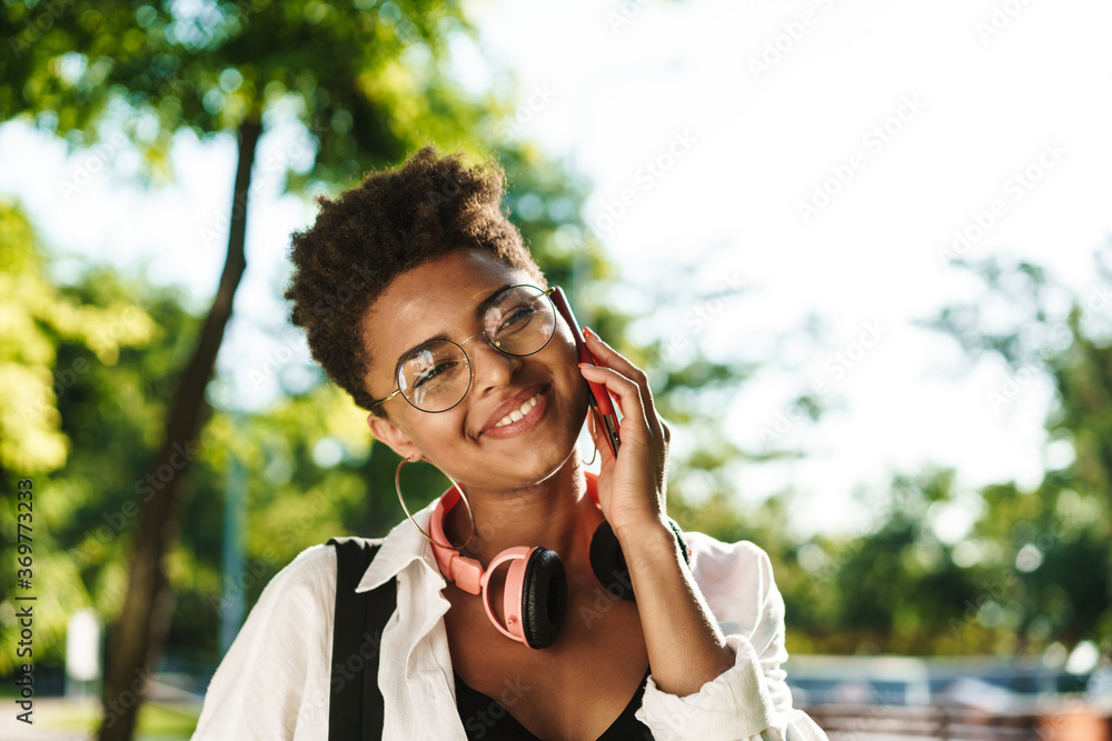 Young cheerful woman chit-chatting on a phone Young cheerful woman chit-chatting on a phone