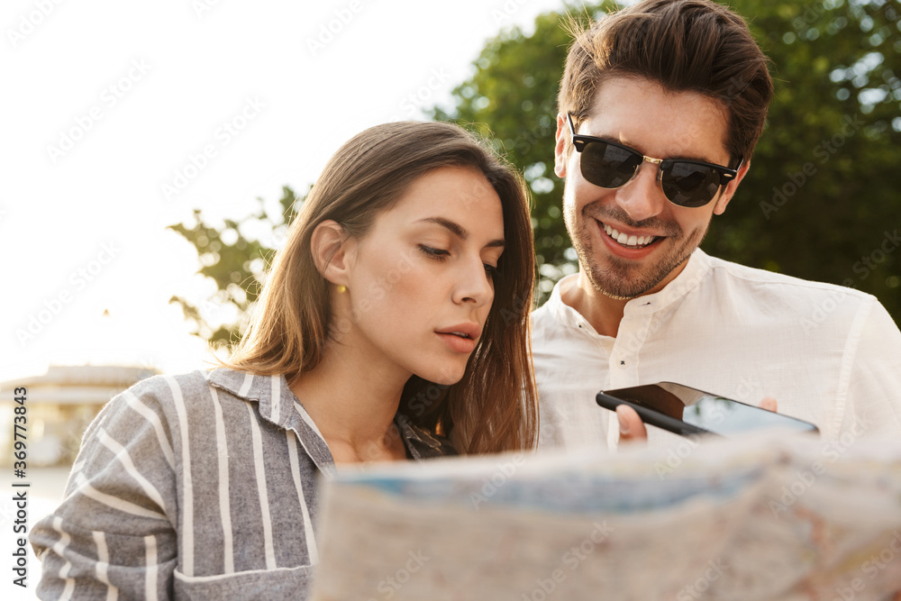 Couple of travelers with map of town Couple of travelers with map of town